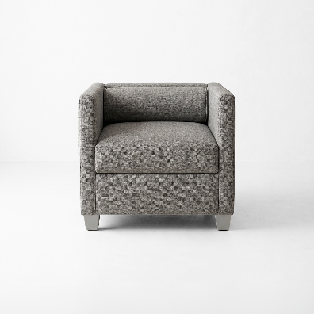 Gray fabric armchair with square arms in a minimalist white studio setting, front view and neutral lighting.