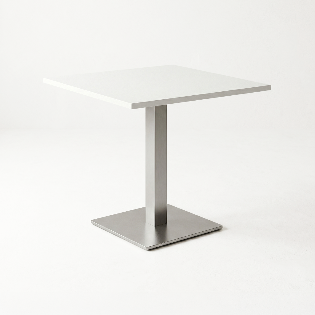 Corner of a modern stainless-steel table with a square pedestal and rectangular top, against a pale background.