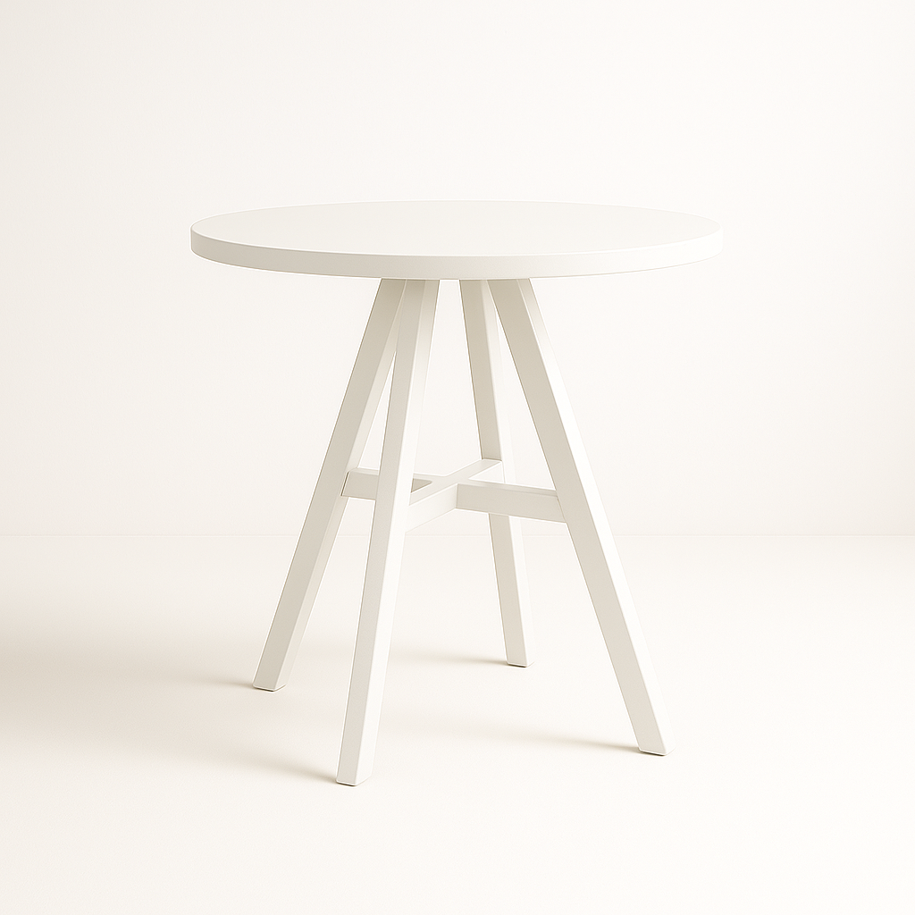 White round tabletop supported by angled white wooden legs in a minimalist studio setting.