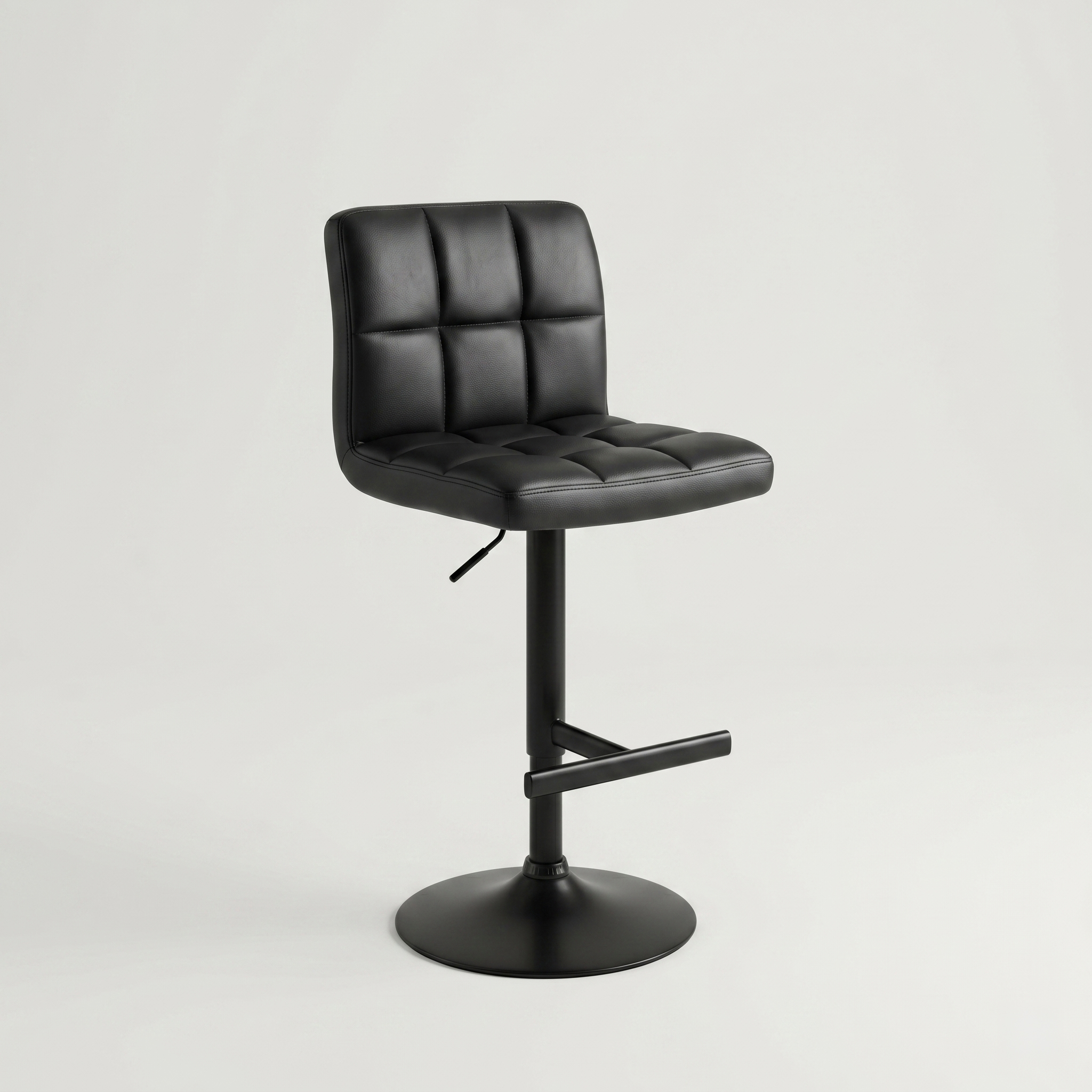 Black leather office chair with tufted back and seat on a round base and central gas lift pedestal.