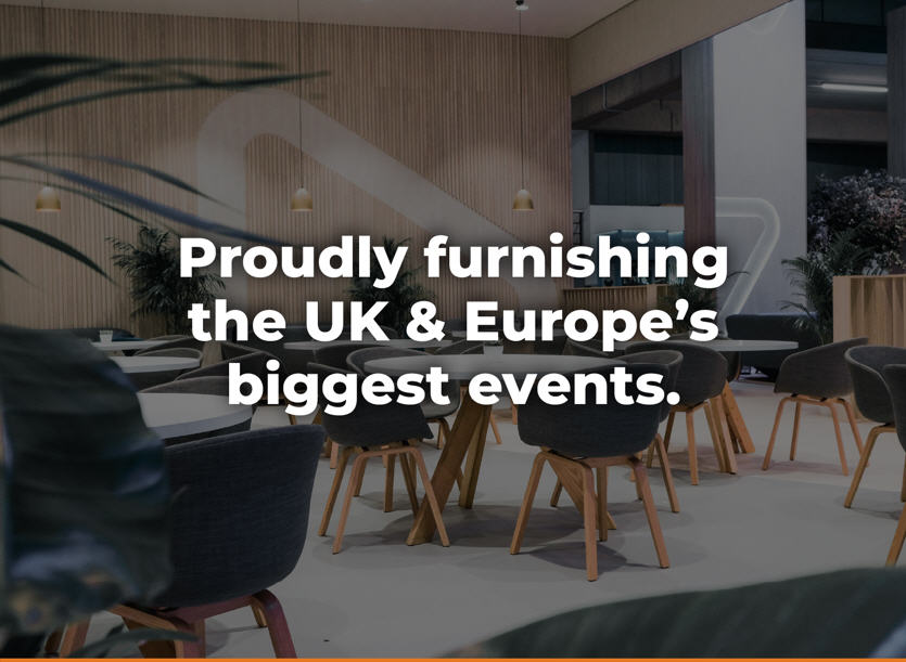 Modern event furniture showroom interior with round tables and wooden chairs; bold white text reads, 'Proudly furnishing the UK & Europe’s biggest events.'